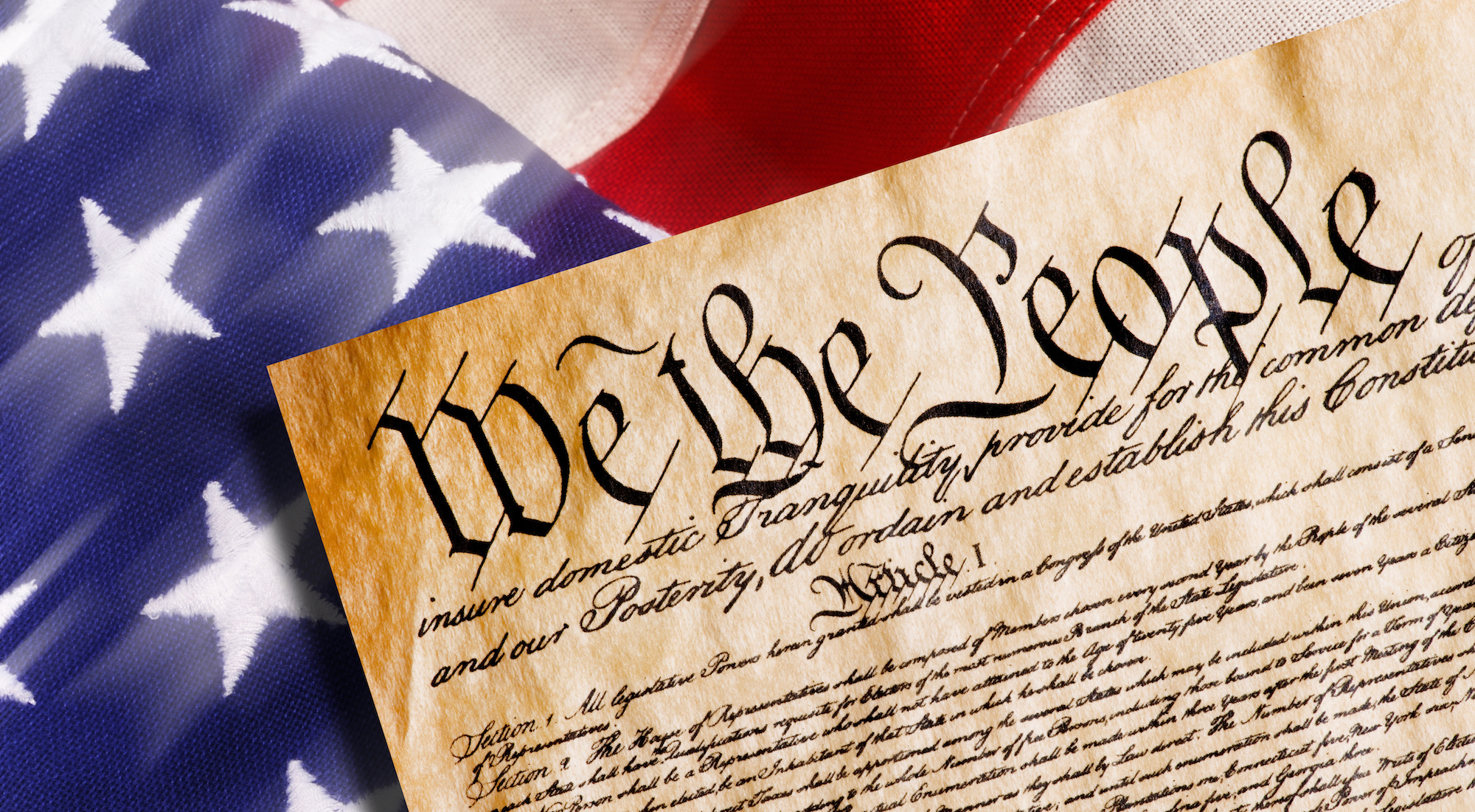 Close-up of the United States Constitution with patriotic lighting